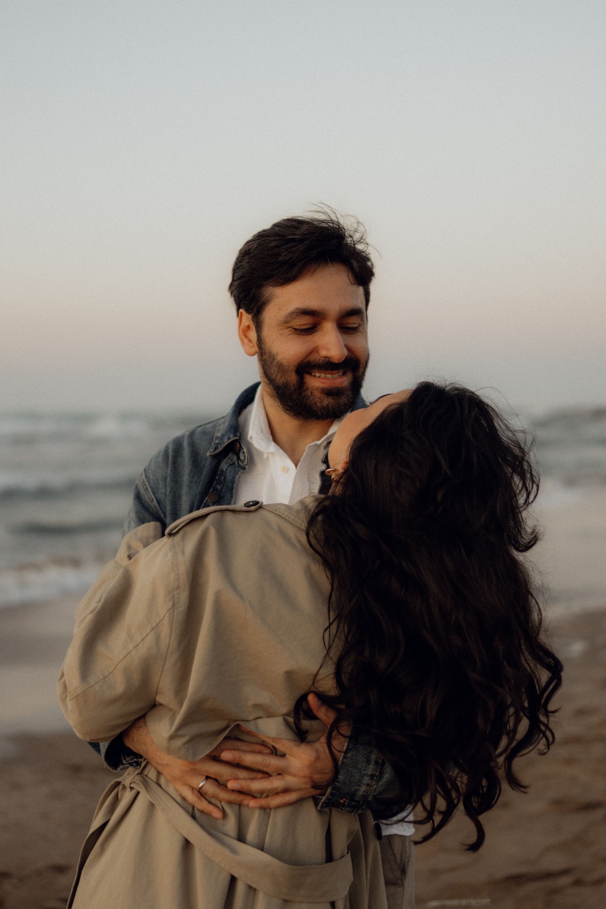 A couple dancing together beside the sea