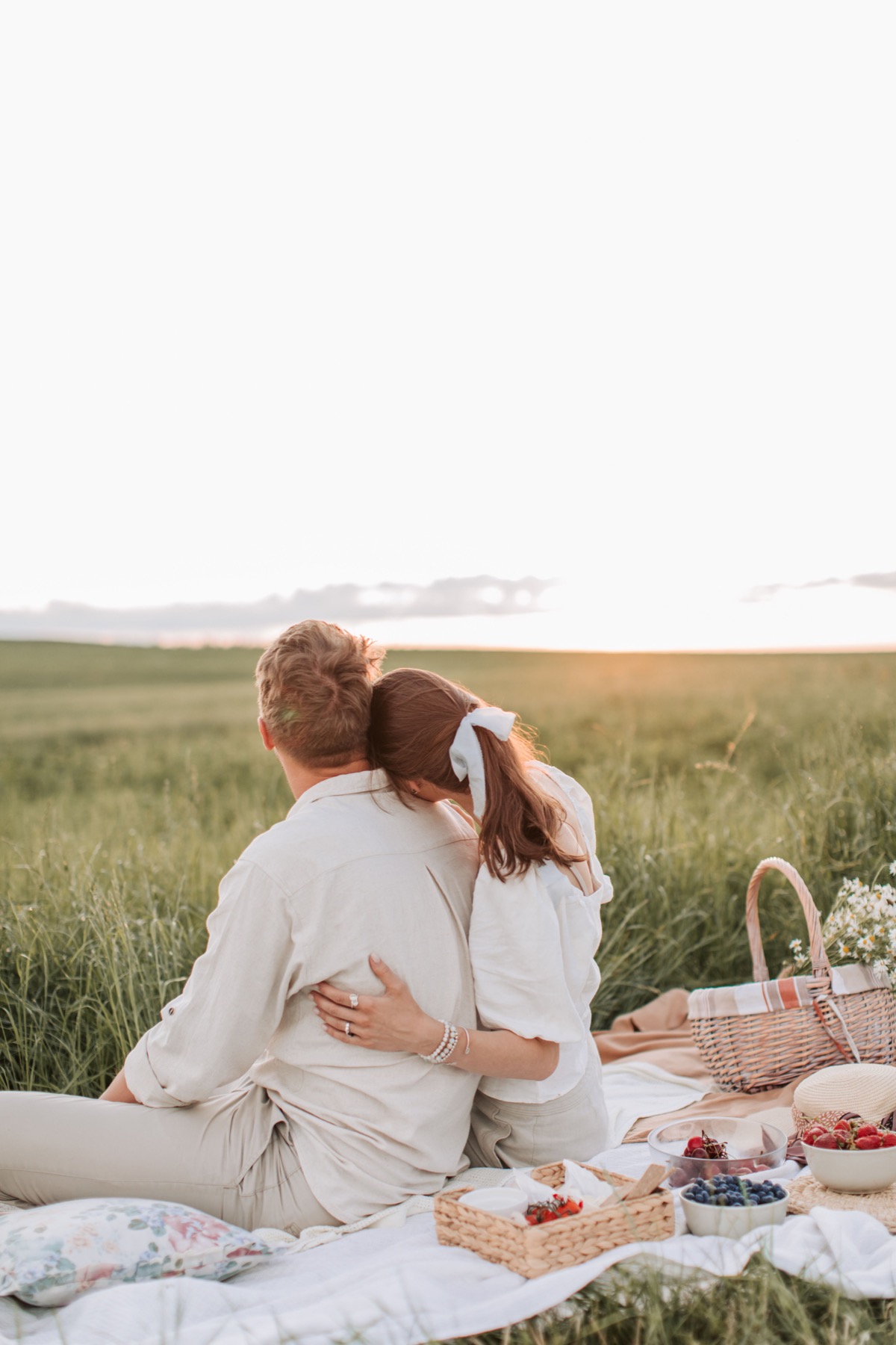 A couple sharing a quiet picnic at sunset