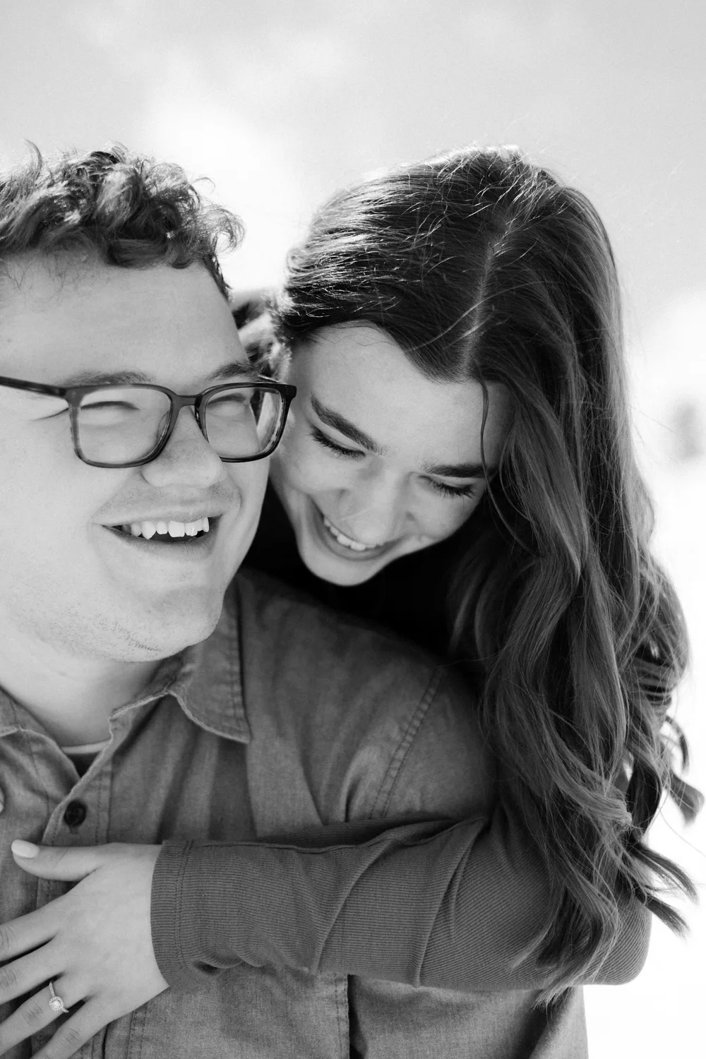 A couple laughing during a piggyback ride